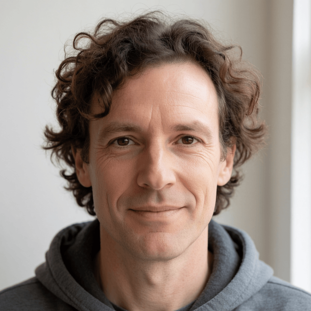 Kenneth Macleod — archival researcher in his Wellington study, working with plantation record copies. Portrait.